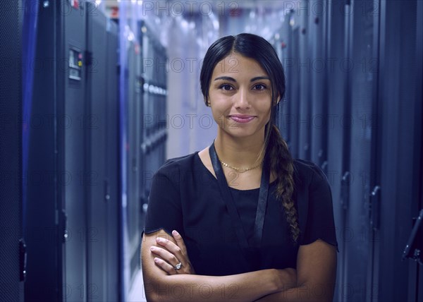 Portrait of smiling female technician in server room