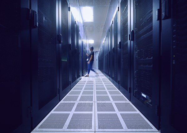 Female technician walking in server room