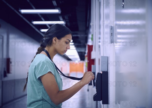 Woman using security card to enter room in data center