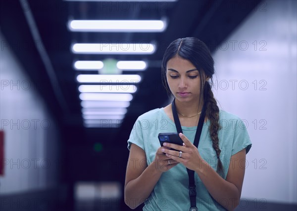 Female technician looking at smart phone