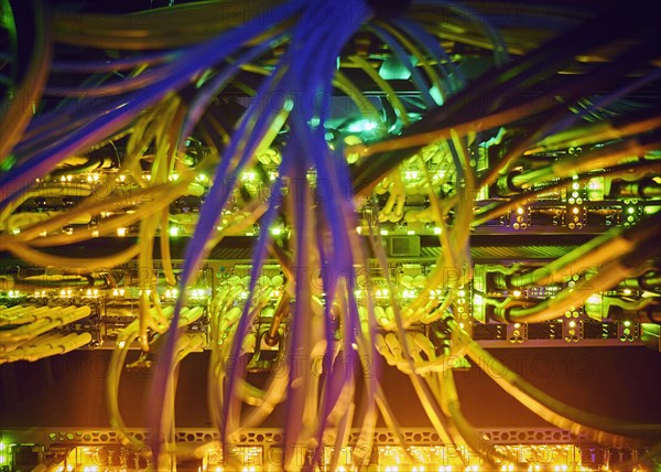 Close-up of tangled computer cables in server room