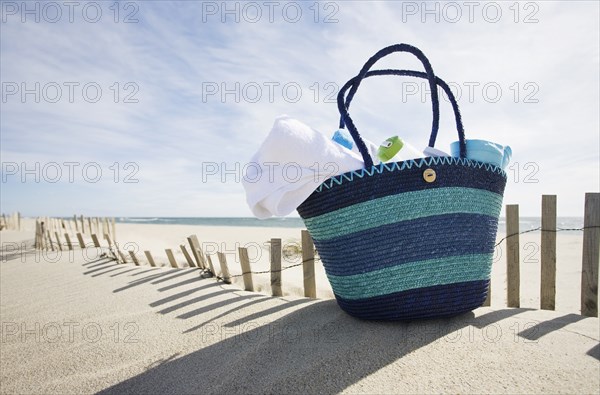 Beach bag with towels on beach