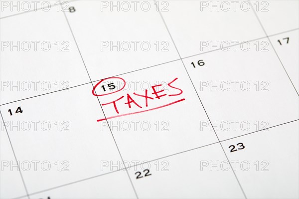 Tax day marked on wall calndar in red