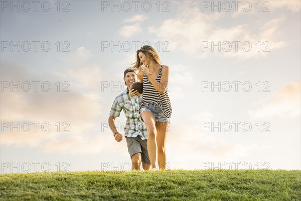 Man running after woman in park