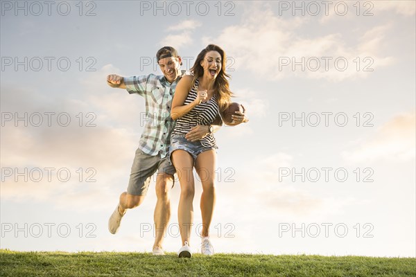 Man and woman playing ball in park