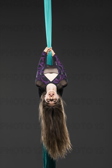 Teenage girl (14-15) during aerial silk practice