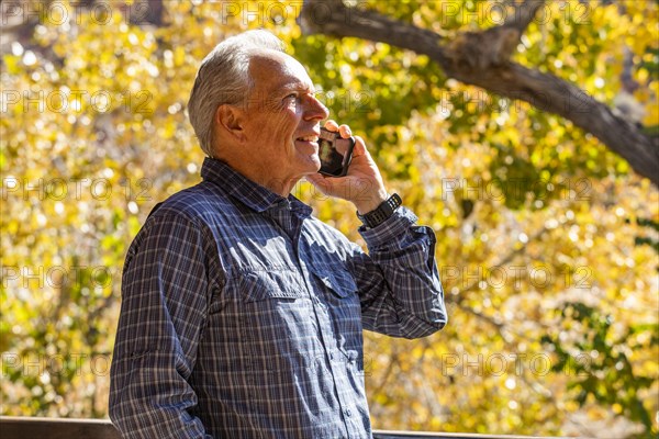 Senior man with smartphone in Zion National Park