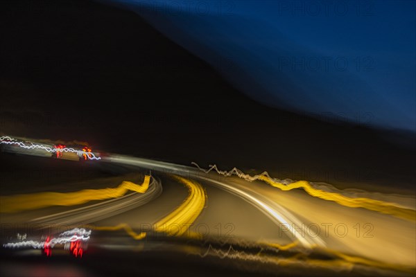 Blurred image of lights on highway at dusk