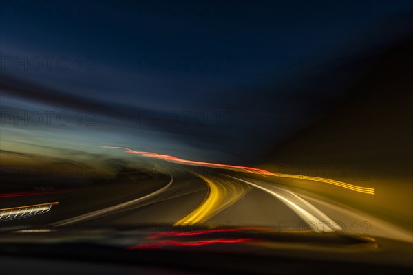 Blurred image of lights on highway at dusk