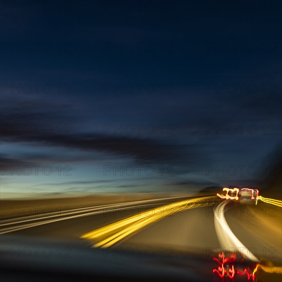 Blurred image of lights on highway at dusk