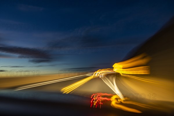 Blurred image of lights on highway at dusk