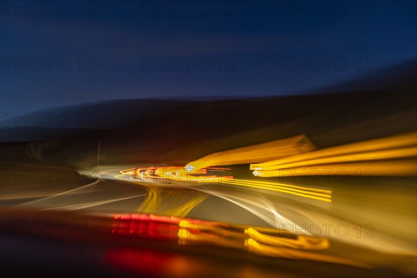 Blurred image of lights on highway at dusk