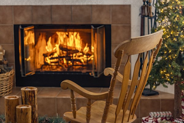 Holiday living room with fireplace and wooden rocking chair