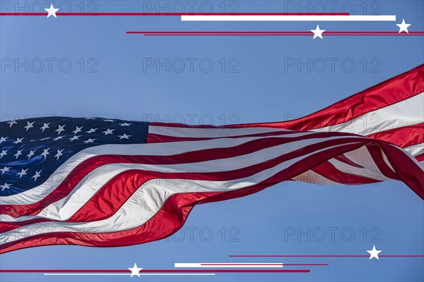 American flag blowing on wind against clear sky