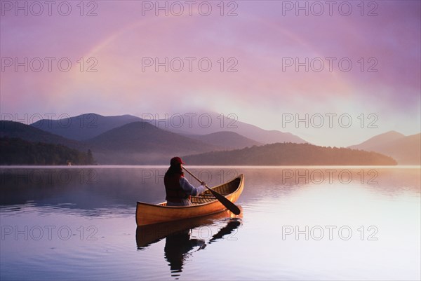 Rear view of woman canoeing