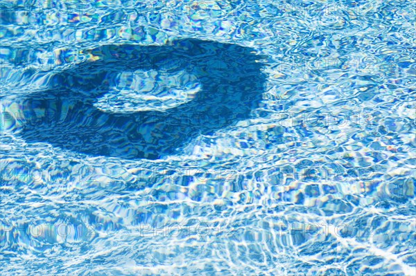 Shadow of inflatable ring on water surface