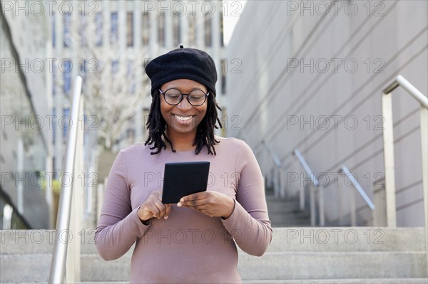 Smiling woman wearing eyeglasses and beret