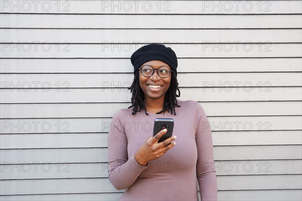 Smiling woman wearing eyeglasses and beret