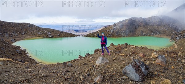 Hiker standing by lake