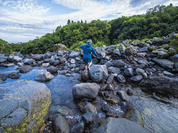 Hiker crossing river