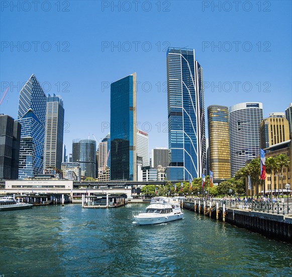 Boat in harbour and modern waterfront architecture