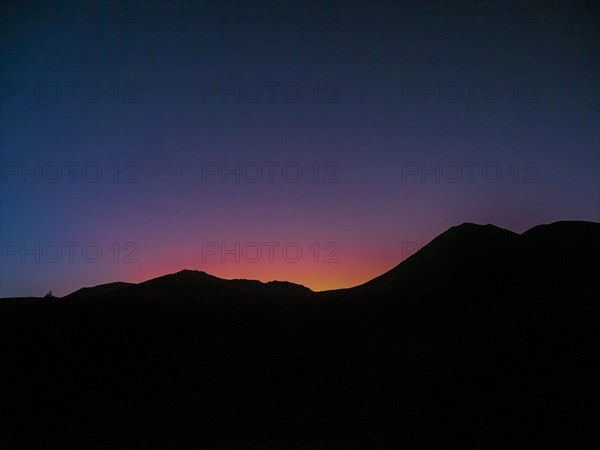 Silhouette of mountain ridge at sunset