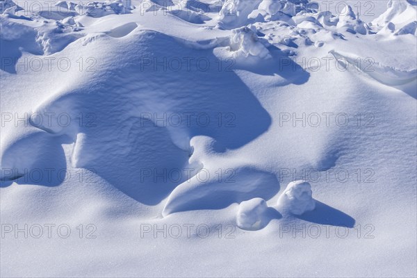 Close-up of sheet of snow at sunny day