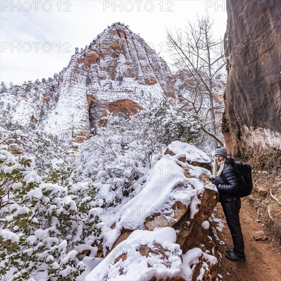 Senior woman hiking in mountains in winter