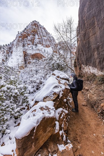 Senior woman hiking in mountains in winter