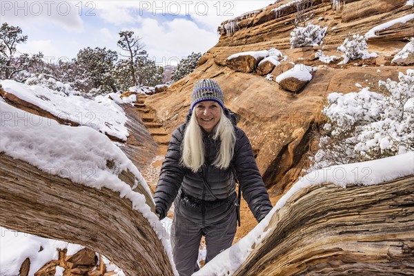 Senior woman hiking in mountains in winter