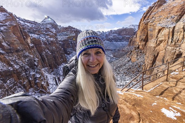 Senior woman hiking in mountains in winter