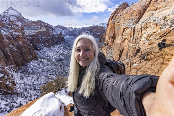 Senior woman hiking in mountains in winter