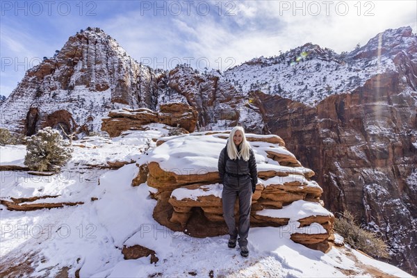 Senior woman hiking in mountains in winter