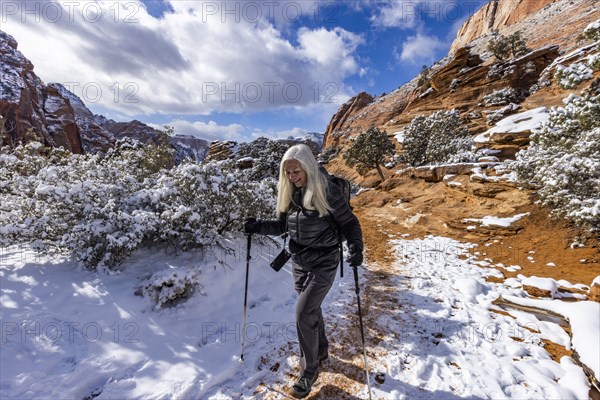 Senior woman hiking in mountains in winter