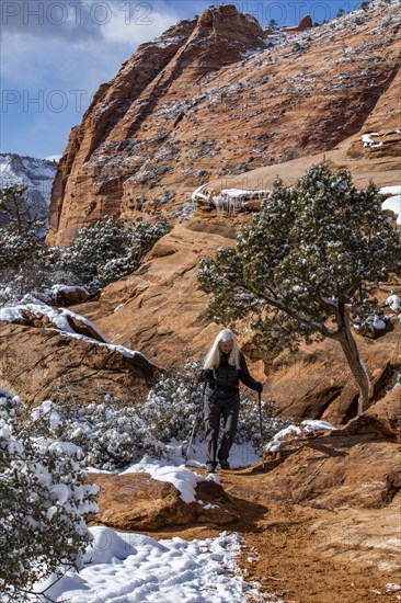 Senior woman hiking in mountains in winter