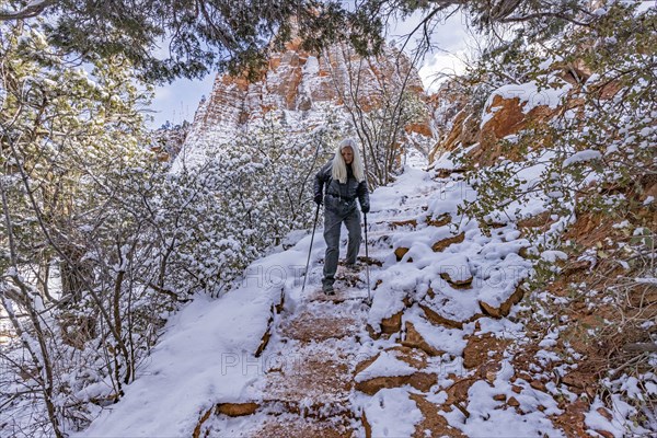 Senior woman hiking in mountains in winter