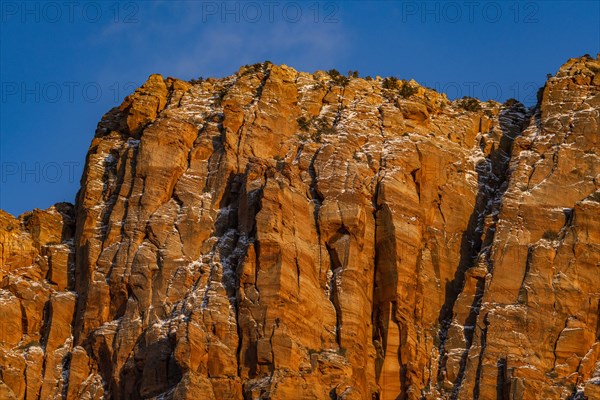 Blue sky above rough rocky mountain