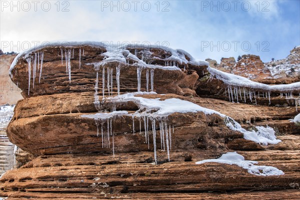 Icicles hanging from rock in mountains