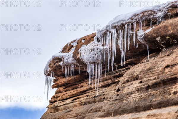 Icicles hanging from rock in mountains