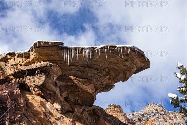 Icicles hanging from rock in mountains