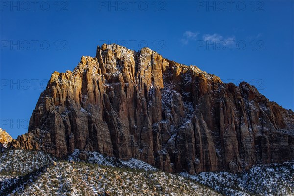 Scenic view of mountain peak against blue sky