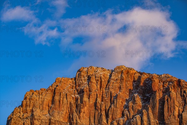 Scenic view of mountain peak against blue sky