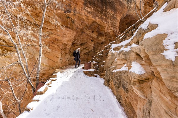 Senior woman hiking in mountains in winter