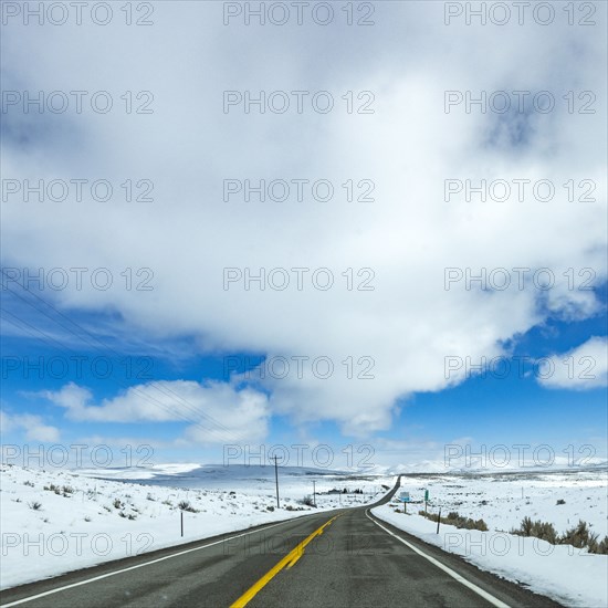 Highway through snow-covered landscape