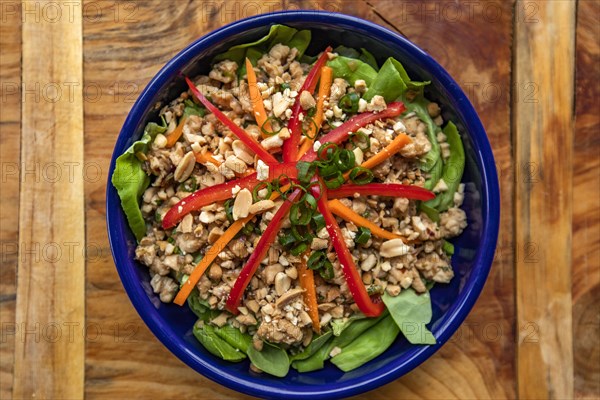 Overhead view of fresh salad on wooden surface