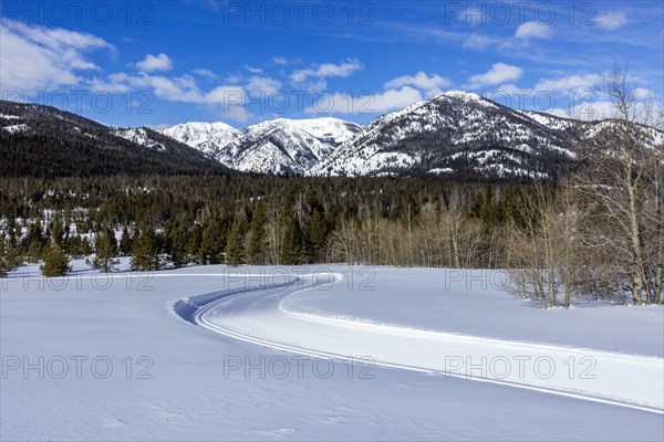 Snow-covered mountains with dirt road