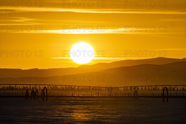 Sunset over hilly landscape