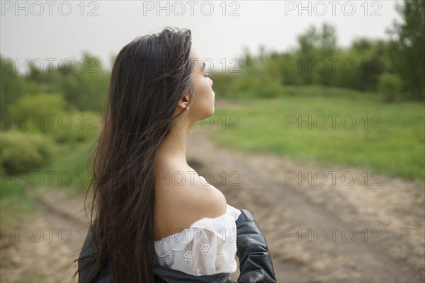 Portrait of teenage girl standing in nature