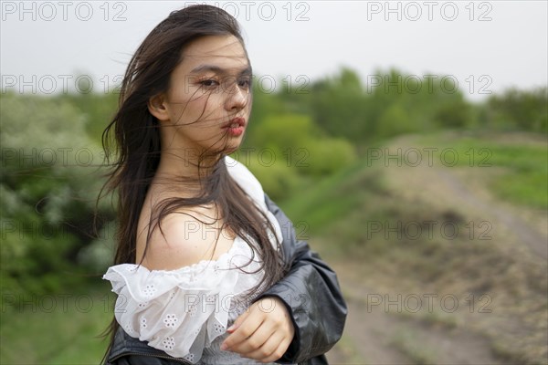 Portrait of teenage girl looking at camera in nature