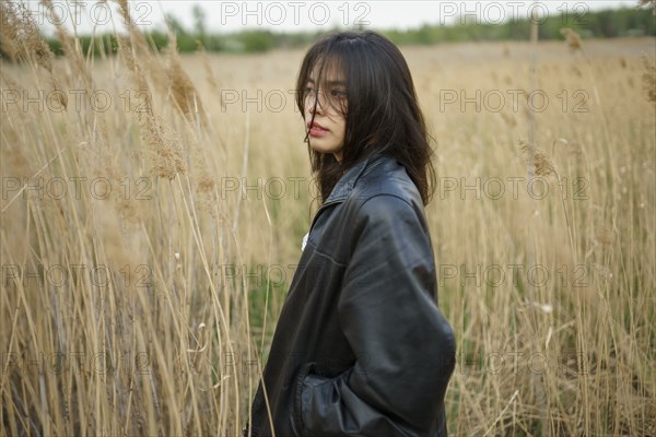 Portrait of teenage girl standing in field